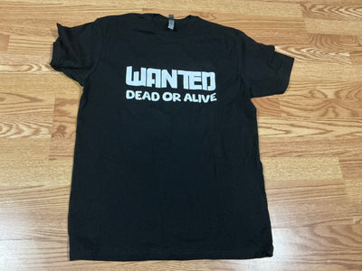 Black t-shirt with 'WANTED DEAD OR ALIVE' text on a wooden surface