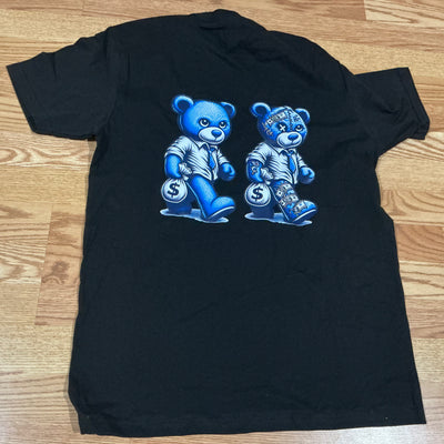 Black t-shirt with blue bear graphics on a wooden surface